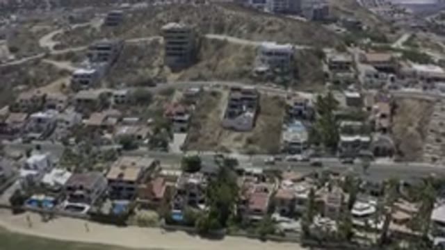LOS CABOS MEXICO-2019: Houses Buildings Land Moving Cars Going Down The Street