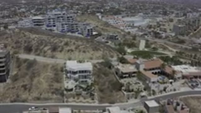 LOS CABOS MEXICO-2019: Sky Rotating View Of Big Houses In Hills With Roads