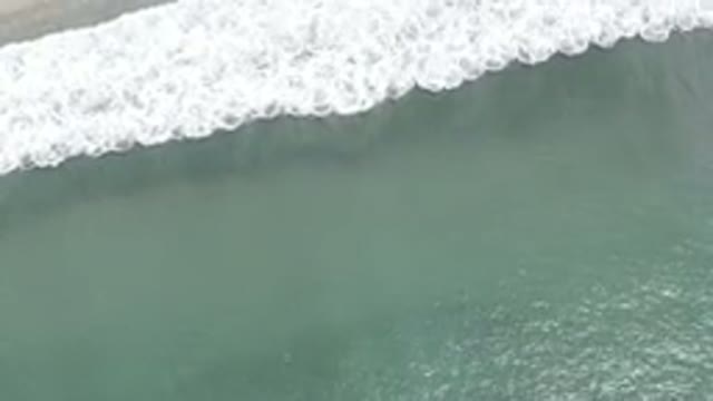 LOS CABOS MEXICO-2019: Drone Footage Above Wave Breaking On Shore With White Sea Foam
