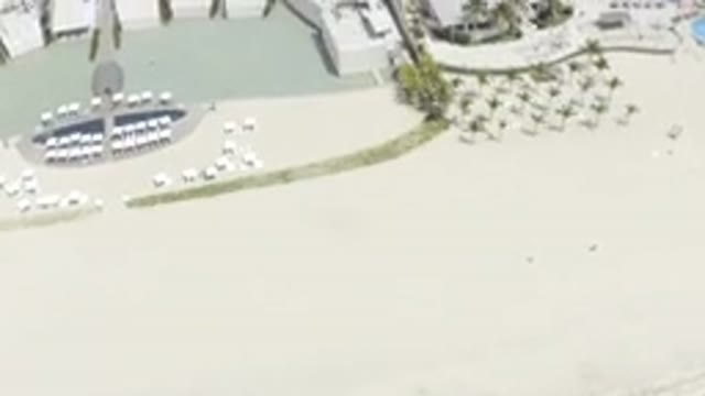 LOS CABOS MEXICO-2019: Aerial View Of Seashore That Pans Over To Beach Resort