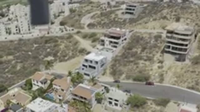 LOS CABOS MEXICO-2019: Drone Footage Over Town Buildings Streets Vehicles