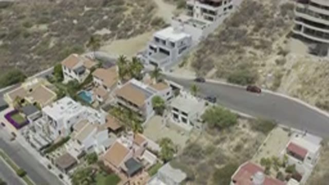 LOS CABOS MEXICO-2019: Drone Footage Over Buildings, Road, Vehicles, Pool, and Desert