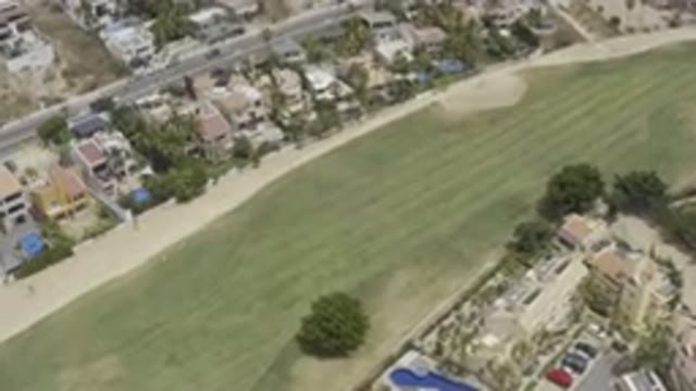 LOS CABOS MEXICO-2019: Bird's Eye View of Neighborhood Houses, Grass, Cars, and Road