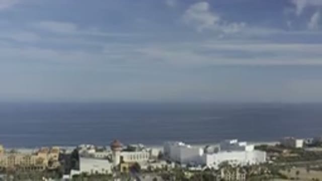 LOS CABOS MEXICO-2019: Blue Sky Underneath Sea with Buildings Trees and Roads