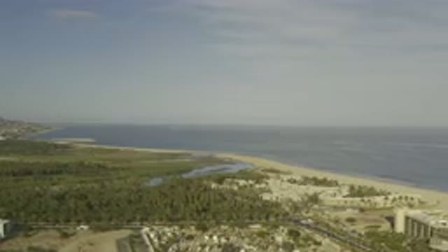 LOS CABOS MEXICO-2019: A Clear Sky Shadowing Over The Sandy Area With A Grassy