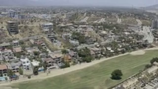 LOS CABOS MEXICO-2019: Drone Footage Over Town Buildings Grassy Area Swimming Pools