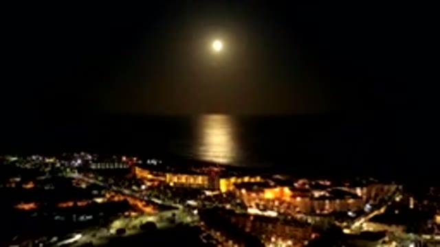 LOS CABOS MEXICO-2019: Sun Is Setting Over A Body Of Water And A Dark City