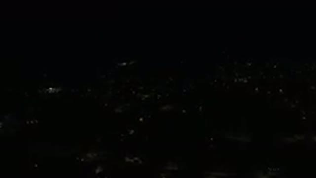 LOS CABOS MEXICO-2019: High Flying Drone Hovers Over a Low Lit City at Night