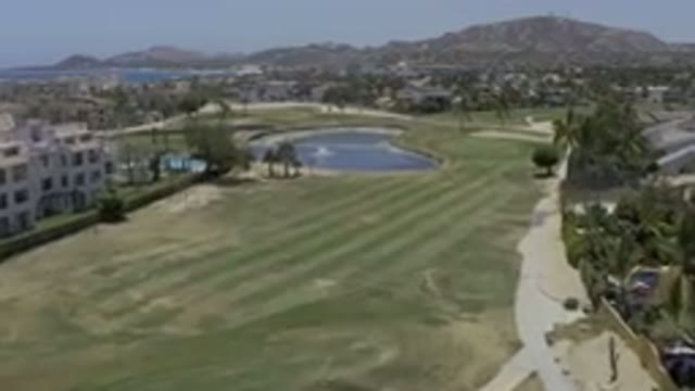 LOS CABOS MEXICO-2019: A Lake In The Center Of An Open Field Of Grass Coconut
