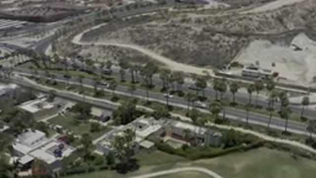 LOS CABOS MEXICO-2019: Overhead View Of Cars Driving Down Highway With Palm Trees