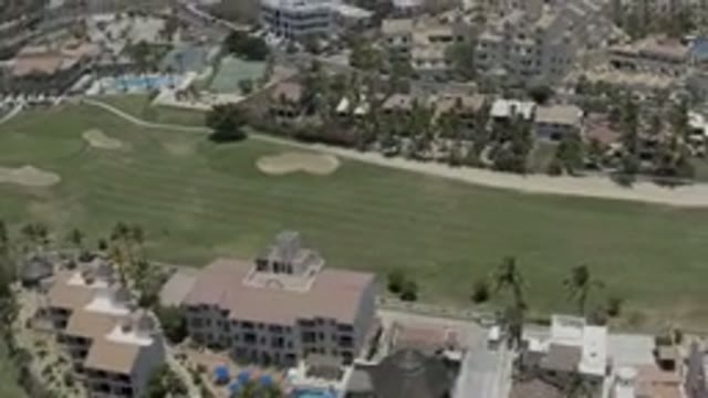 LOS CABOS MEXICO-2019: Drone Footage Over Town Buildings Homes Grass Area Palm