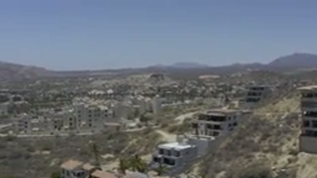 LOS CABOS MEXICO-2019: Abandoned Homes on Ugly Hills in Arid Landscape