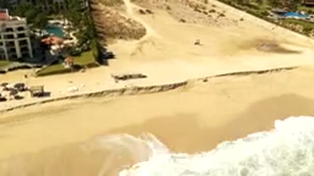 LOS CABOS MEXICO-2019: A Young Boy on a High Seashore Behind Public Area
