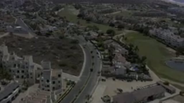 LOS CABOS MEXICO-2019: A Beautiful View of a Lot, Buildings, Grassland and Moving Cars