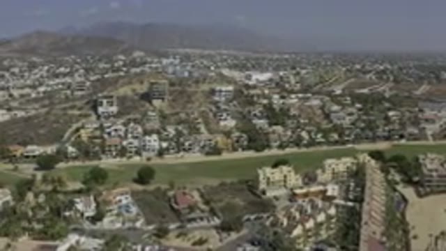 LOS CABOS MEXICO-2019: Drone Footage Over City Buildings Streets Swimming Pool