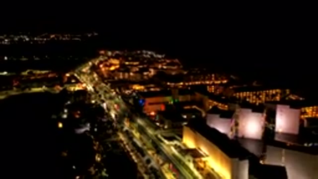 LOS CABOS MEXICO-2019: Busy Street At Night Lots Of Traffic Buildings Lit Up And