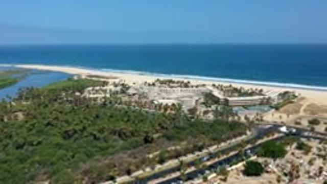 LOS CABOS MEXICO-2019: Blue Waves Hitting Brown Sand Shoreline