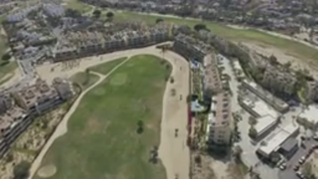 LOS CABOS MEXICO-2019: A Sky View Of A Sunny Golf Course Surrounded By Tall