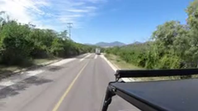 LOS CABOS MEXICO-2019: Vehicle Driving Past on Highway with Trees