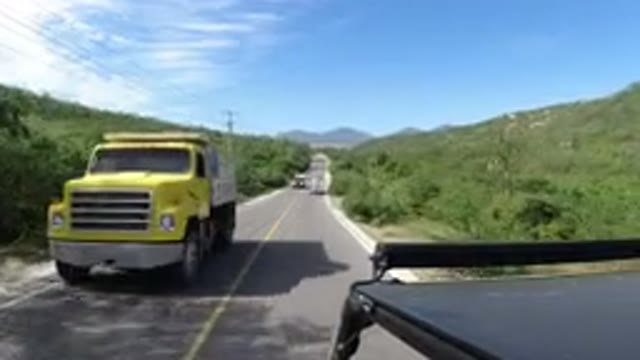 LOS CABOS MEXICO-2019: A Vehicle On The Center Moving On The Road And Other Two
