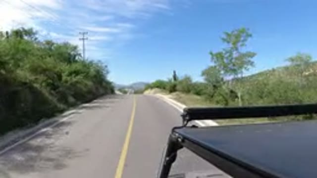 LOS CABOS MEXICO-2019: Vehicle Driving Through Long Road With Both Sides Trees & Bushes