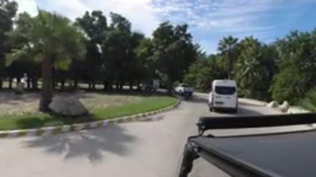 LOS CABOS MEXICO-2019: Clean Road With Green Grass Trees Around And A Black