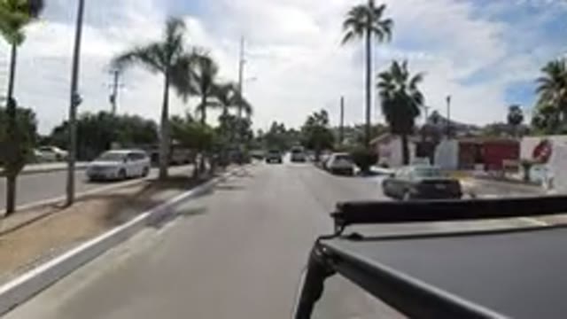 LOS CABOS MEXICO-2019: Vehicle Drives Down Divided City Street With Buildings On