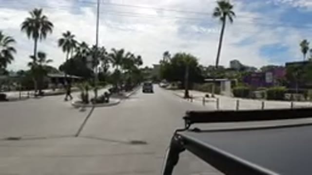 LOS CABOS MEXICO-2019: Black Car Speeds Down Road To Catch Car In Front