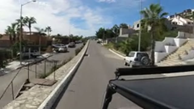 LOS CABOS MEXICO-2019: Man Driving In A Beautiful And Calm Street With A Camera
