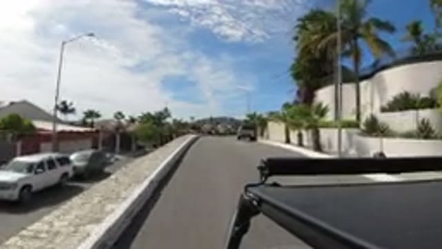 LOS CABOS MEXICO-2019: Peaceful Driving On A Sunny Road Along The Green Grass And Trees