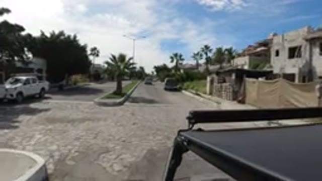 LOS CABOS MEXICO-2019: Black Car Switches To Driving On The Wrong Side Of The Road