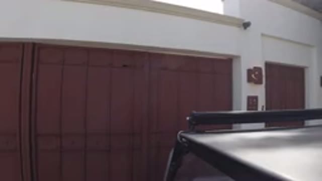 LOS CABOS MEXICO-2019: Black Car Parked in Front of New House with Red Doors