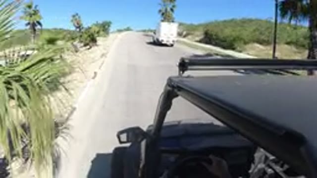 LOS CABOS MEXICO-2019: Driving Dusty Open Road with White Truck and Black Vehicle