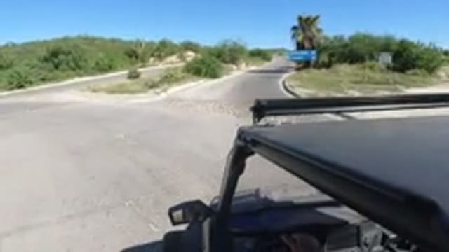 LOS CABOS MEXICO-2019: Car Takes Right Turn at Road Junction with Blue Sign