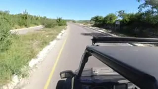 LOS CABOS MEXICO-2019: A Small SUV Driving Fast Around a Highway Curve