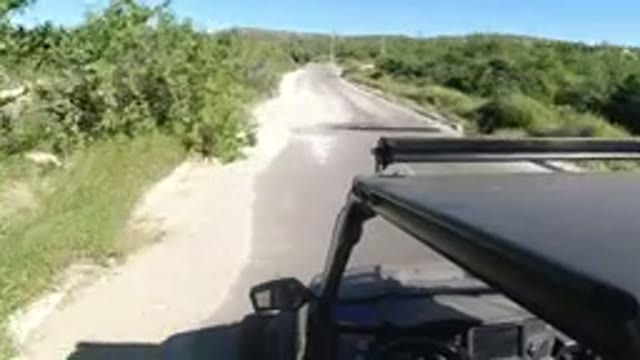 LOS CABOS MEXICO-2019: A Mini SUV Is Driving Very Fast Down A Lonely Road That
