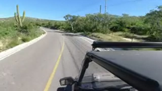 LOS CABOS MEXICO-2019: Single Black Vehicle Driving On Winding Road Abundant
