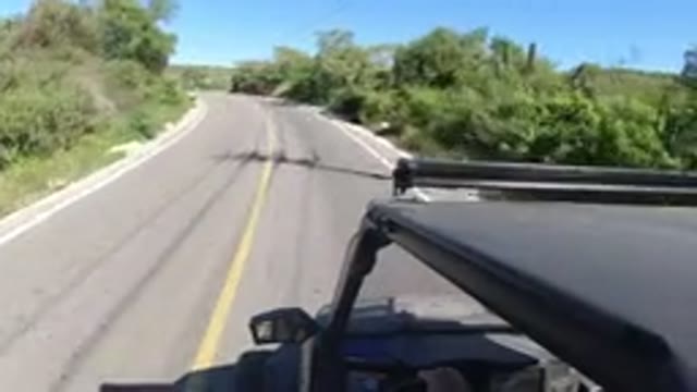 LOS CABOS MEXICO-2019: Driving Car On Two Way Road With Trees Around At Moderate