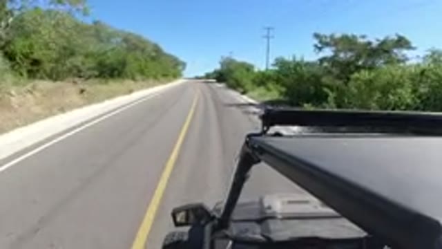 LOS CABOS MEXICO-2019: Car Drives Down Road With Sand Blown Onto It