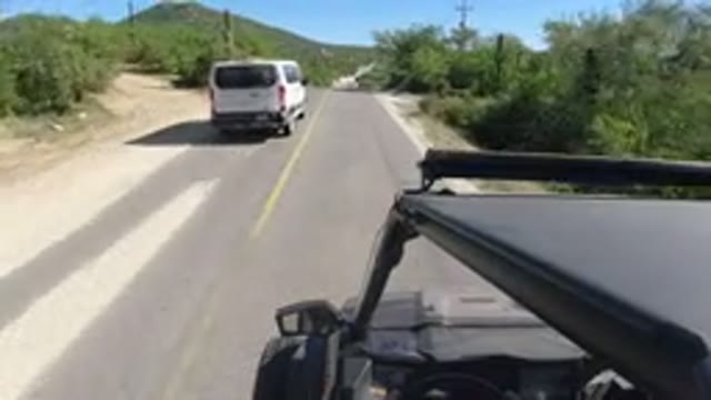 LOS CABOS MEXICO-2019: White Van Speeding Past Car on Highway During Sunny Day