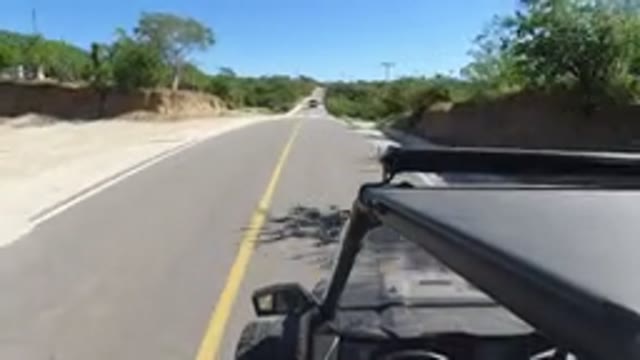 LOS CABOS MEXICO-2019: A Small SUV Driving Very Fast On A Lonely Highway With
