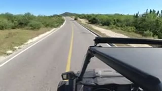 LOS CABOS MEXICO-2019: SUV Traveling Down Two Lane Highway No Other Vehicles On