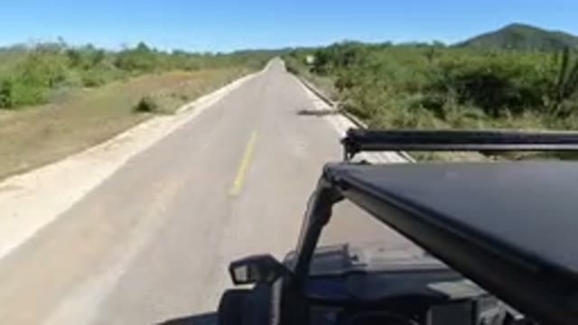 LOS CABOS MEXICO-2019: A Small SUV Driving With Speed Down The Lonely Highway