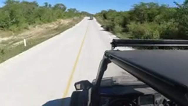 LOS CABOS MEXICO-2019: Fast Moving Jeep Type Vehicle Down Single Paved Road In