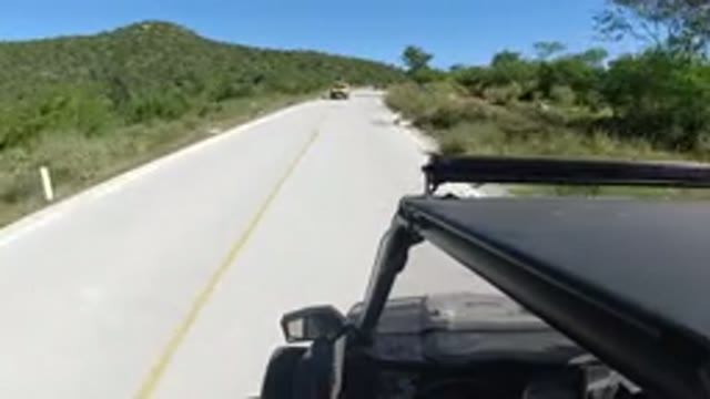 LOS CABOS MEXICO-2019: A Car Drives Fast On The Road Passing By Another
