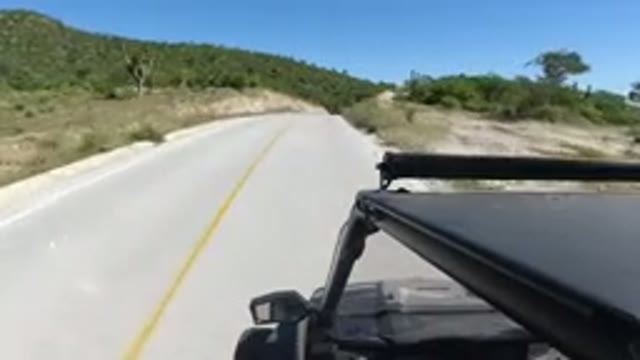 LOS CABOS MEXICO-2019: Car Or Jeep Driving Down An Almost Empty Two Lane Highway