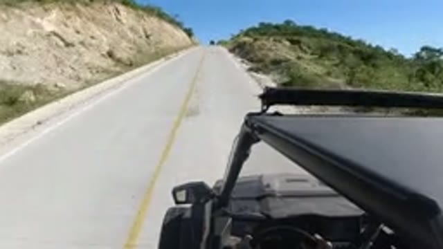 LOS CABOS MEXICO-2019: A Small SUV Traveling Fast Down A Lonely Highway