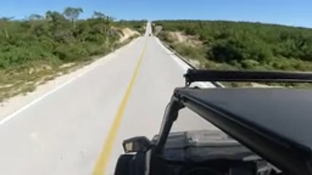 LOS CABOS MEXICO-2019: Black Car Driving Fast On An Empty Public Road