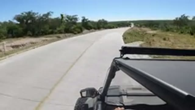 LOS CABOS MEXICO-2019: Black Car Driving On A Paved Road On A Sunny Day