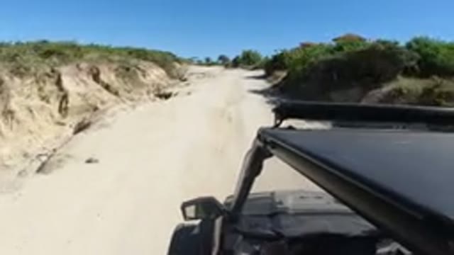 LOS CABOS MEXICO-2019: Moving SUV On A Dirt Road Traveling By What Looks Like A Hotel